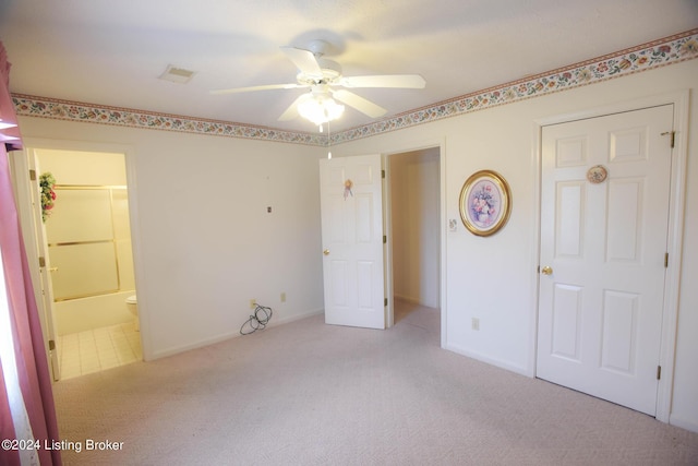 unfurnished bedroom featuring connected bathroom, ceiling fan, and light carpet