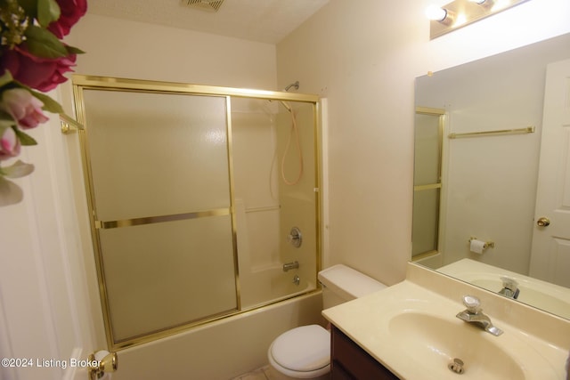 full bathroom with shower / bath combination with glass door, vanity, and toilet