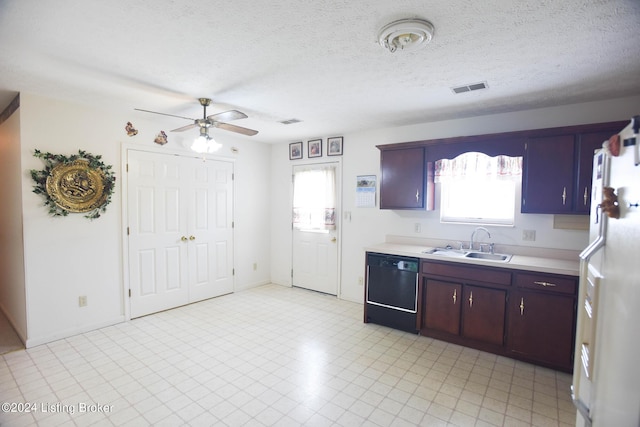 kitchen featuring dishwasher, white refrigerator, sink, ceiling fan, and a textured ceiling