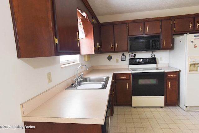 kitchen with dark brown cabinetry, electric stove, sink, and white refrigerator with ice dispenser