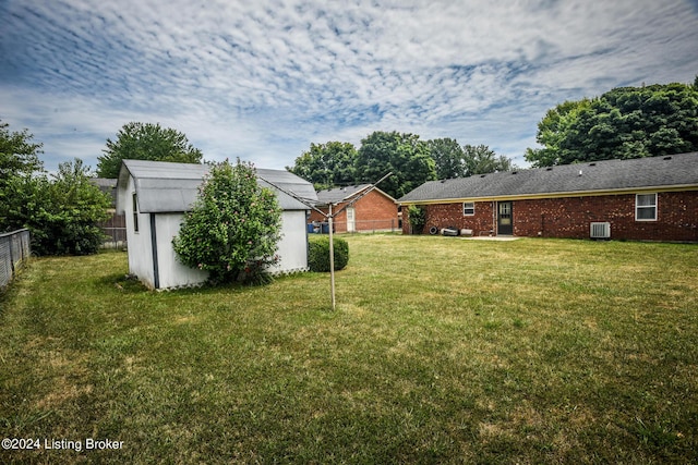 view of yard with a shed and central air condition unit