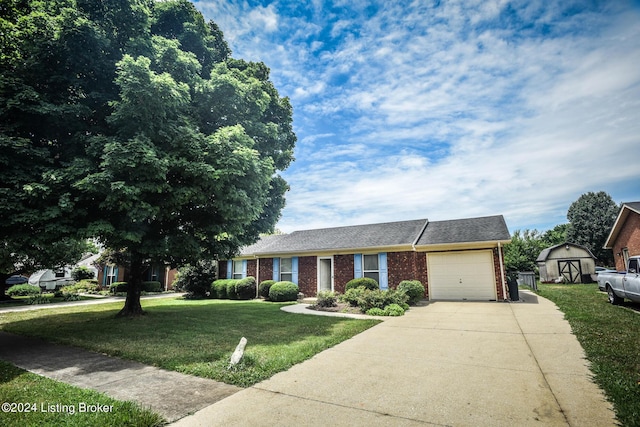 view of front of home featuring a storage unit, a garage, and a front yard