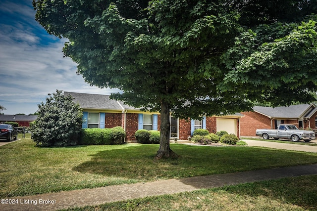 view of front of property with a front yard and a garage