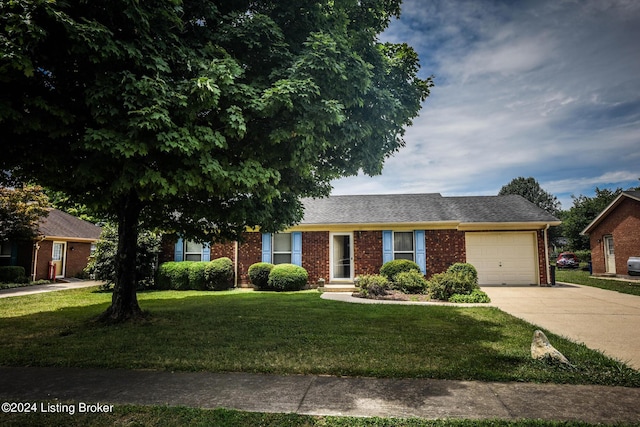 ranch-style house featuring a garage and a front lawn