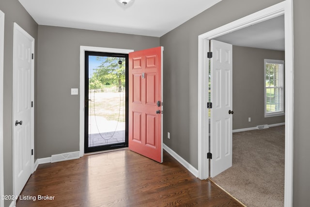 foyer with dark colored carpet