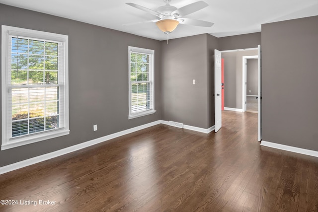 spare room with dark wood-type flooring and ceiling fan