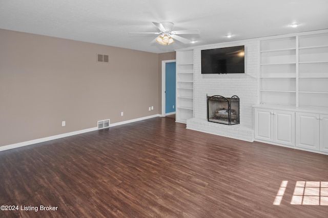 unfurnished living room featuring dark wood-type flooring, a fireplace, and ceiling fan