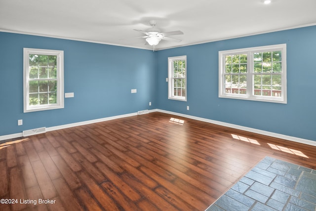 unfurnished room featuring dark wood-type flooring and ceiling fan