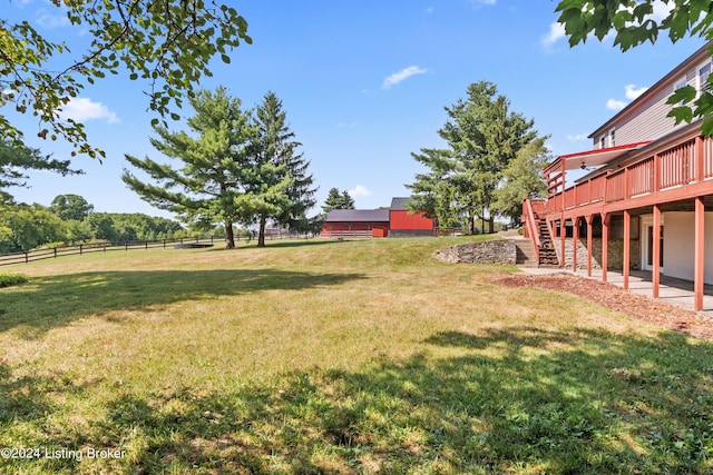 view of yard featuring a wooden deck and a rural view