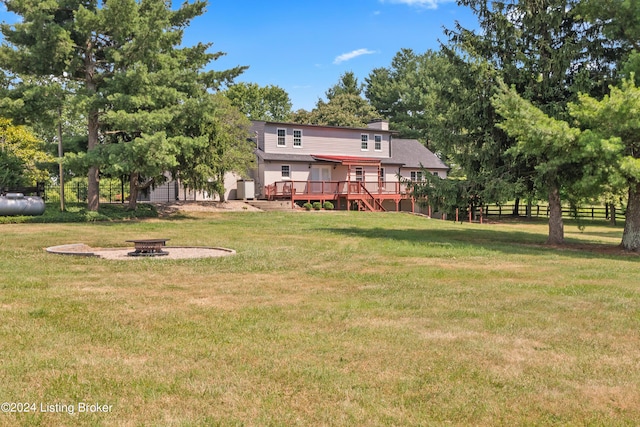 view of yard with a wooden deck and an outdoor fire pit