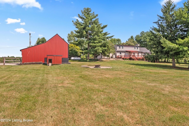 view of yard featuring a wooden deck and an outdoor fire pit