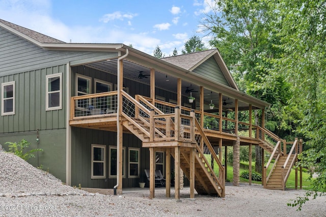 rear view of property with a wooden deck and ceiling fan