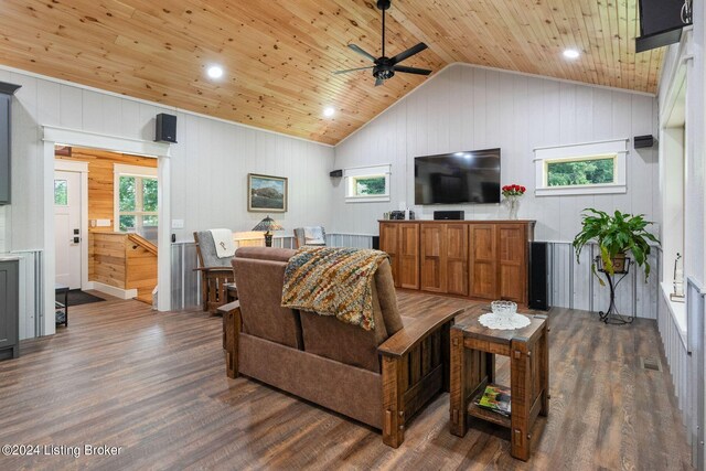 living room with wood walls, vaulted ceiling, wooden ceiling, dark hardwood / wood-style floors, and ceiling fan