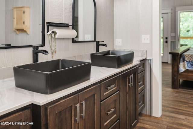 kitchen with dark wood-type flooring, sink, and dark brown cabinets