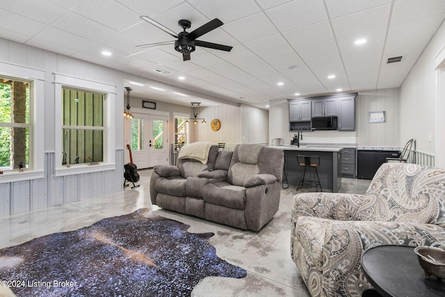 living room featuring ceiling fan and sink