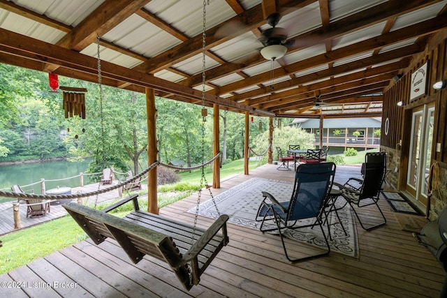 wooden deck featuring ceiling fan and a water view