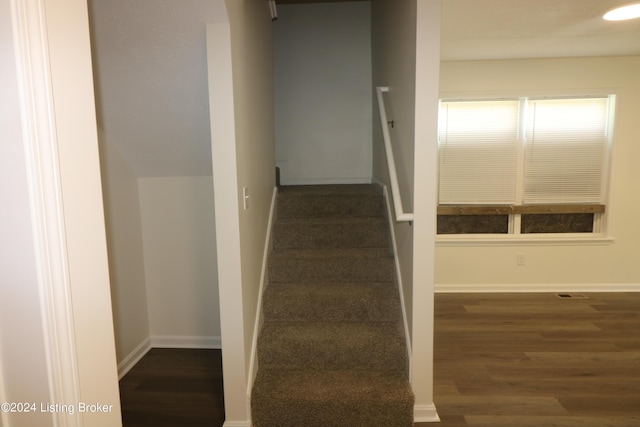 stairs featuring hardwood / wood-style floors