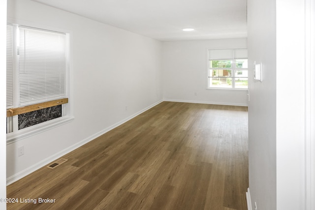 spare room with dark wood-type flooring