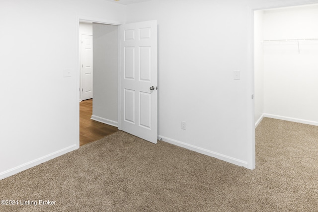 unfurnished bedroom with carpet flooring and a closet