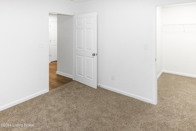 2425 Elliott Ave, Louisville, KY 40211 - unfurnished bedroom featuring carpet flooring, a spacious closet, baseboards, and a closet