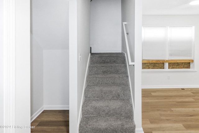 stairs with wood-type flooring