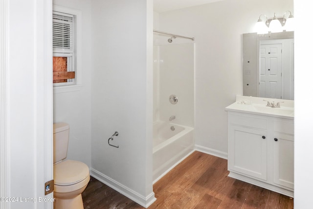 full bathroom with hardwood / wood-style floors, vanity, toilet, and washtub / shower combination