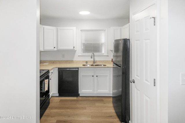 kitchen featuring black appliances, light hardwood / wood-style floors, white cabinetry, and sink