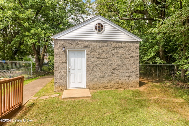 view of outbuilding with a lawn