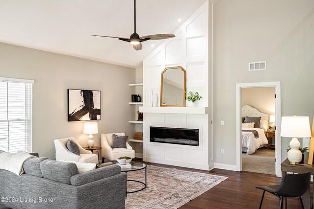 living area featuring dark wood-style floors, visible vents, ceiling fan, high vaulted ceiling, and baseboards