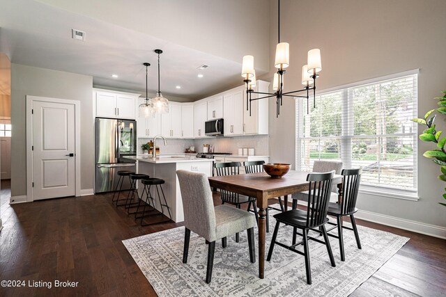 dining area with baseboards, visible vents, a chandelier, and dark wood-style flooring