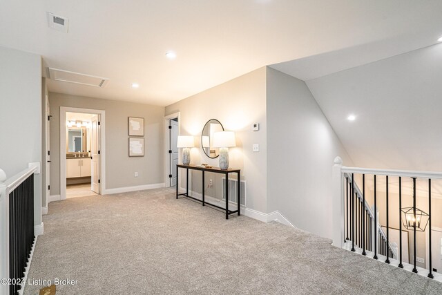 hall featuring recessed lighting, visible vents, carpet flooring, and an upstairs landing