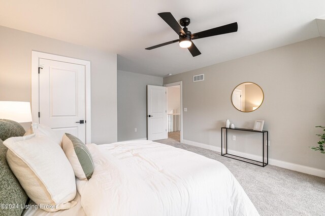 bedroom with carpet floors, visible vents, ceiling fan, and baseboards