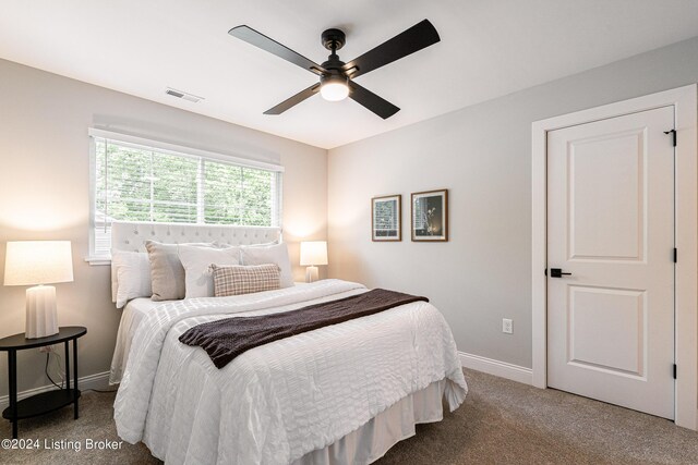 carpeted bedroom with ceiling fan, visible vents, and baseboards