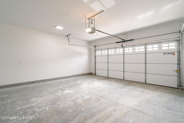 garage with a garage door opener and baseboards