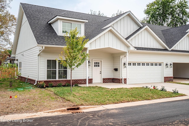 view of front of house with a garage, driveway, a shingled roof, and board and batten siding