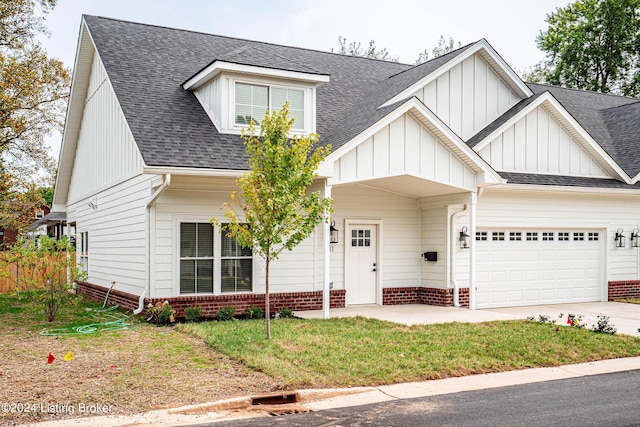 view of front facade with a garage, driveway, roof with shingles, and board and batten siding