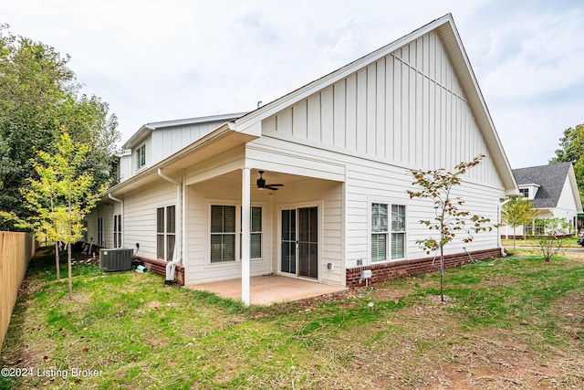 rear view of house featuring ceiling fan, a patio, fence, a yard, and board and batten siding