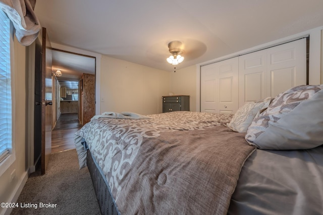 bedroom with dark carpet, a closet, and ceiling fan