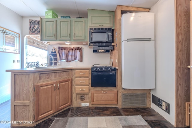 kitchen featuring black microwave, white fridge, sink, and range with gas cooktop