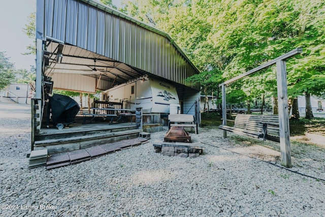 exterior space featuring grilling area and an outdoor fire pit