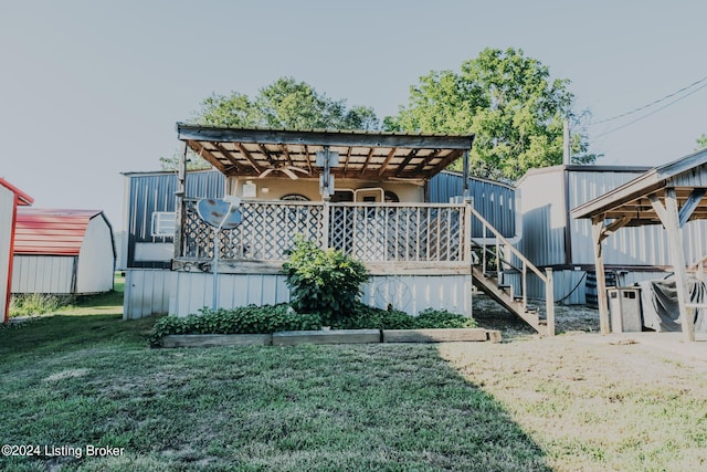 rear view of property with a yard