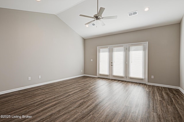 empty room featuring lofted ceiling, dark wood-type flooring, and ceiling fan