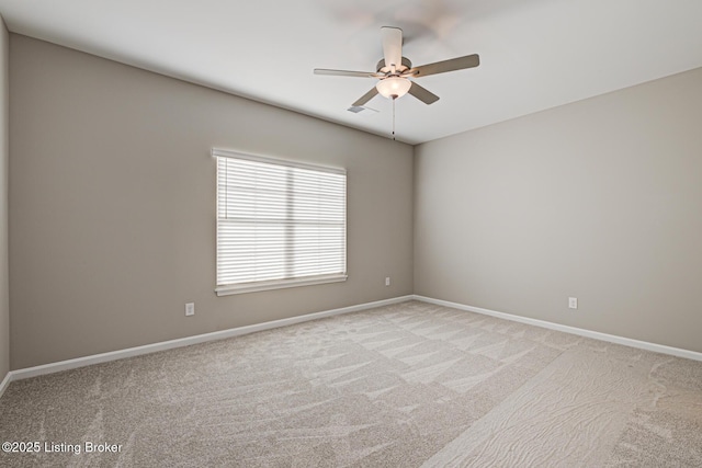 carpeted spare room featuring ceiling fan