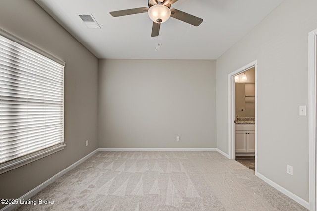 spare room with light carpet and ceiling fan