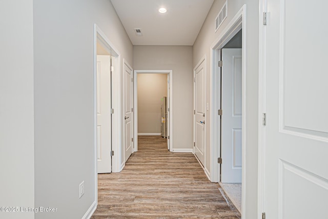 corridor with light wood-type flooring