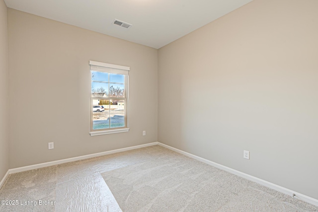 spare room featuring light colored carpet