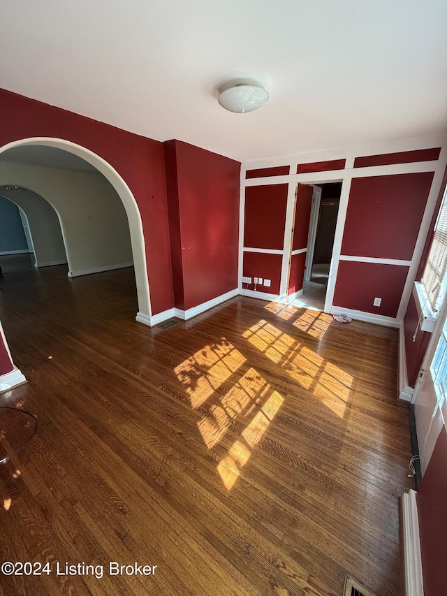 unfurnished room featuring dark wood-type flooring