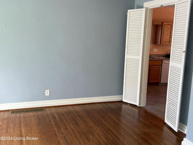 spare room with dark hardwood / wood-style flooring