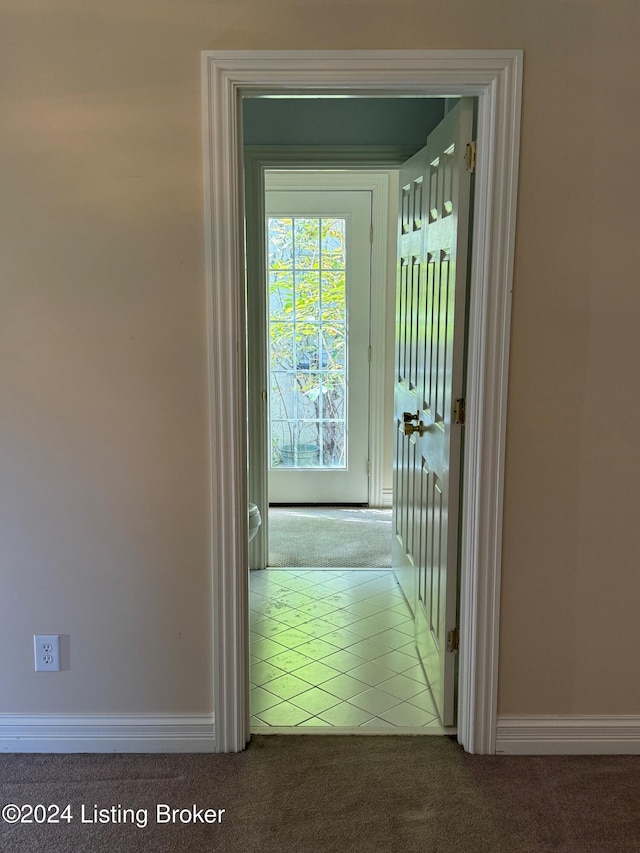 hall featuring light colored carpet