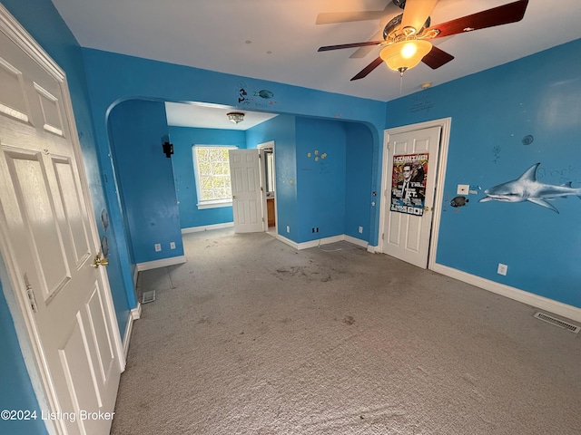 unfurnished bedroom featuring carpet flooring and ceiling fan